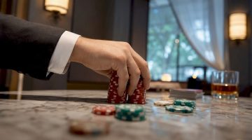 Una mano apostando fichas sobre la mesa del casino