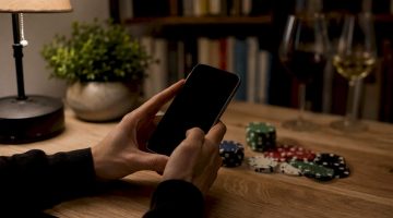 Manos sujetando un teléfono para apostar en el casino